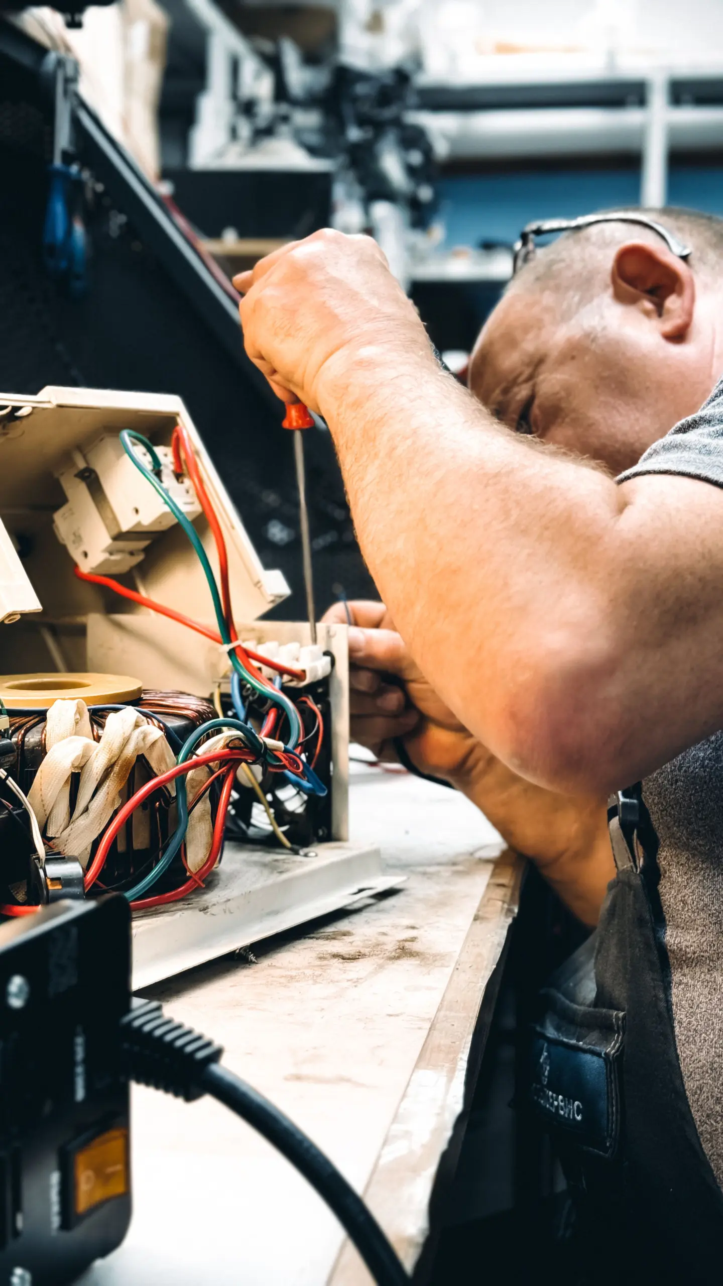Professionally trained appliance technician performing diagnostic repair on modern refrigerator